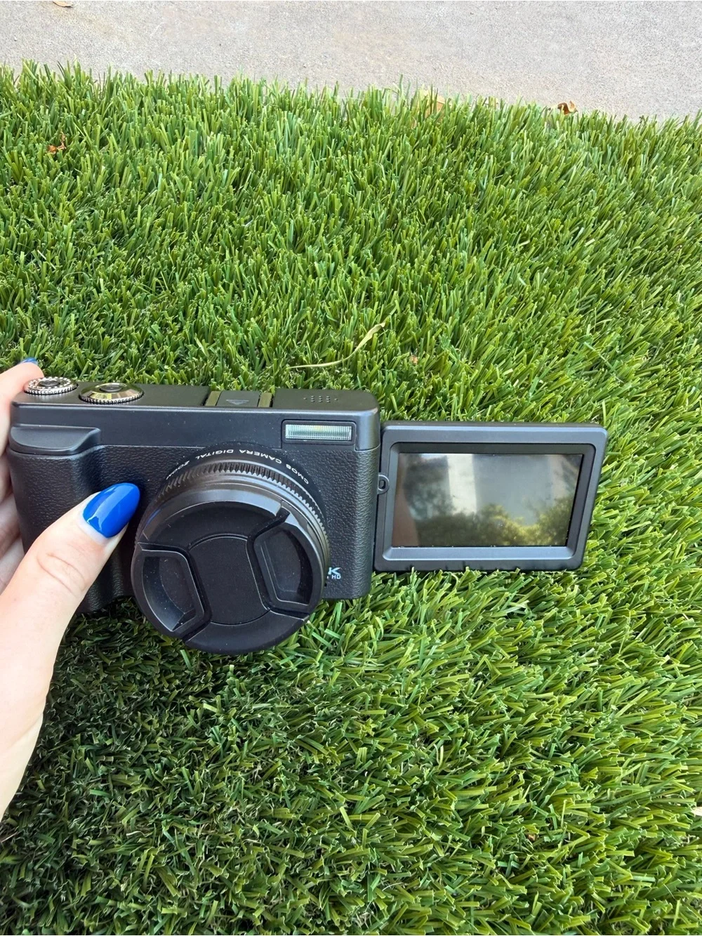 Compact Black Digital Camera with Accessories and Lens Cap